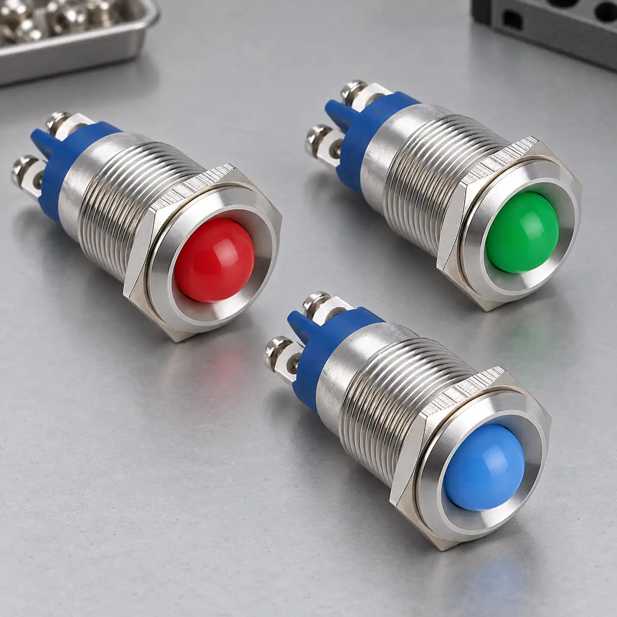 Three GQ16G style red green and blue metal panel indicator lamps with domed lenses and threaded barrels