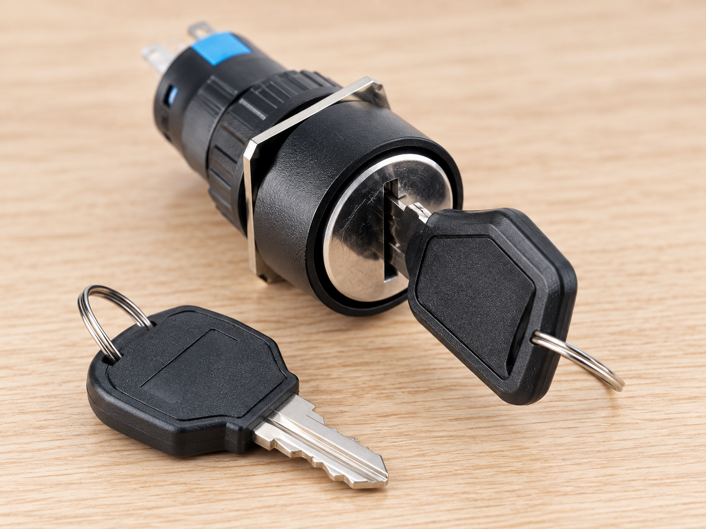 Key Switch Removal Positions: Captive and Removable Keys body2 Black ONPOW keyed operator with inserted key and original blue rear segments with a loose spare key on a documentation bench
