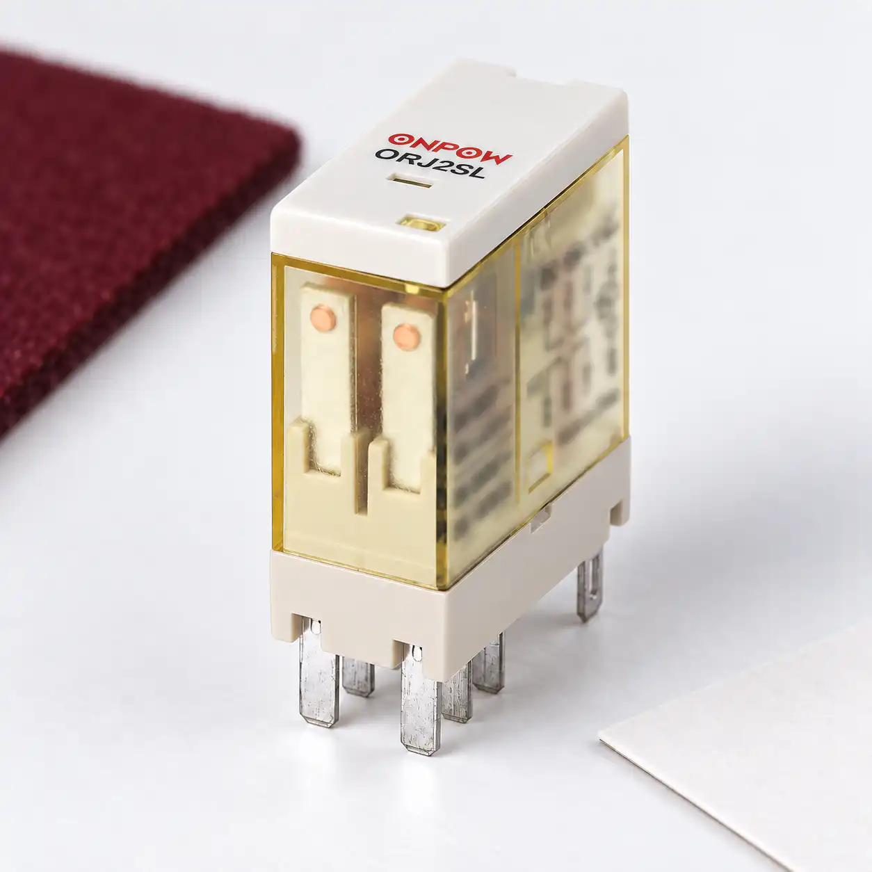 Relay resistive and inductive load rating review body2 Reference-matched transparent ONPOW relay with cream base, visible contact structure and original flat blade terminals, unpowered