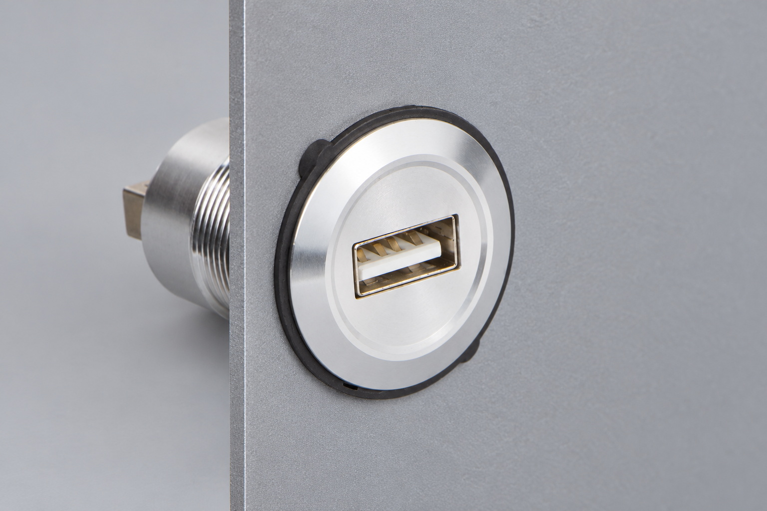 USB-A connector mounted through a flat metal panel