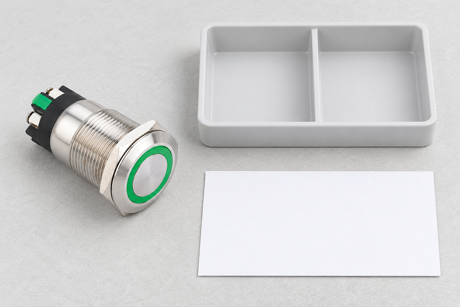 ONPOW metal push button beside a divided stock tray and blank receiving card