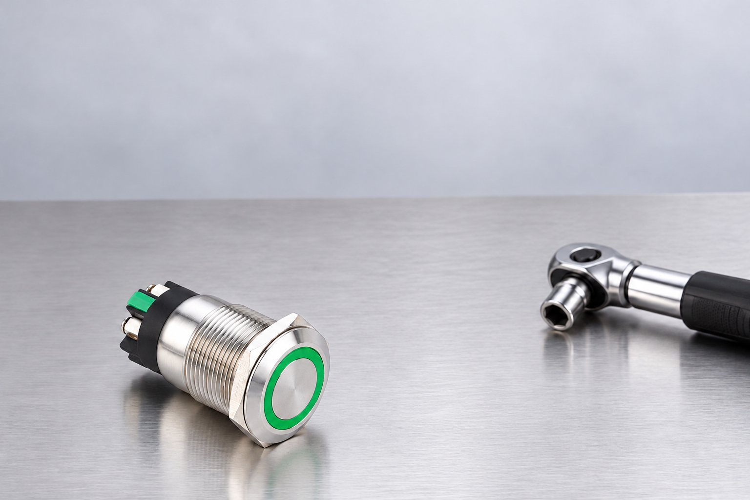 Threaded green-ring switch beside a separate assembly torque tool