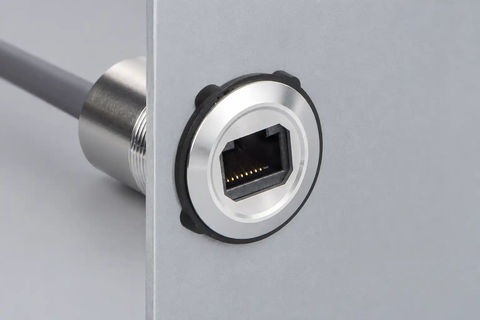 RJ45 panel connector mounted through a flat metal panel